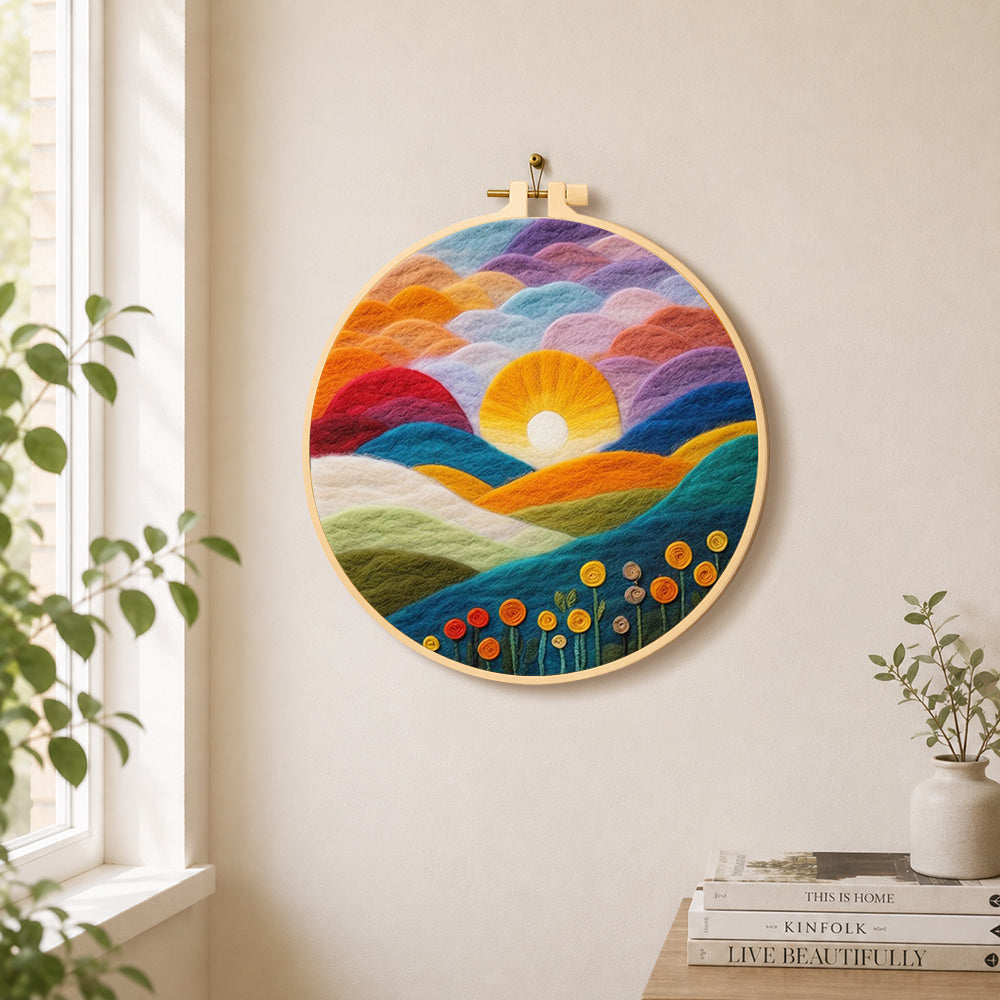 Gradient clouds, bright yellow sunset and colorful hills needle felt wall art displayed in a bright home interior