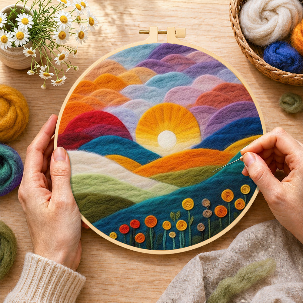 Creating the gradient clouds, bright yellow sunset and colorful hills wool painting by hand with a felting needle