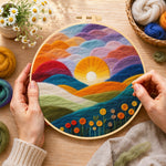 Creating the gradient clouds, bright yellow sunset and colorful hills wool painting by hand with a felting needle
