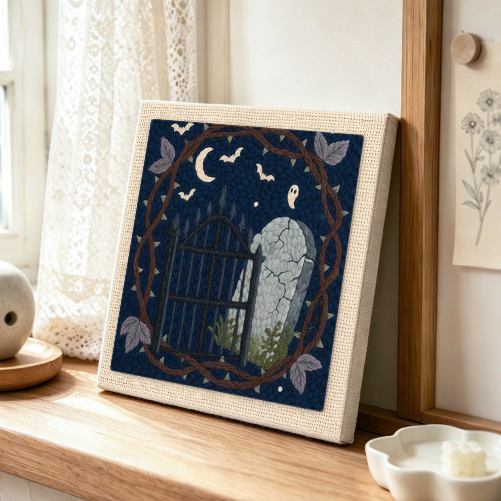 Graveyard night scene punch needle artwork displayed on a table