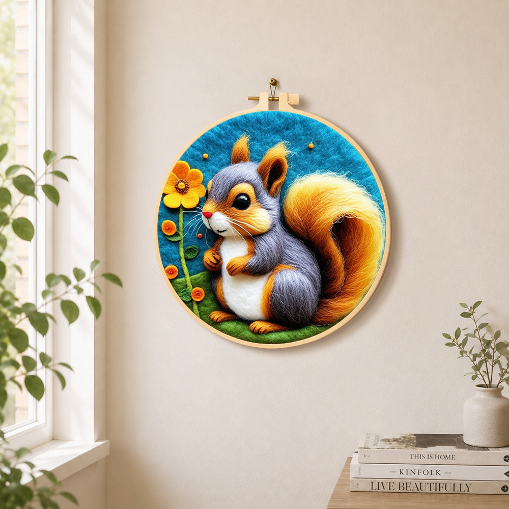 Gray and orange squirrel with golden tail needle felt wall art displayed in a bright home interior
