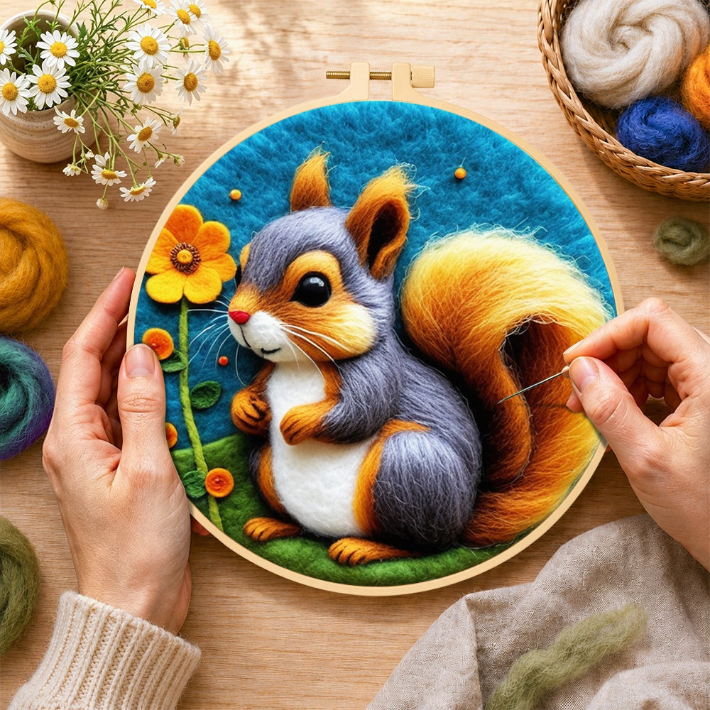 Creating the gray and orange squirrel with golden tail wool painting by hand with a felting needle