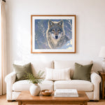 Finished gray wolf portrait in winter snow cross stitch artwork displayed as home decor