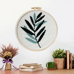 Finished green fern leaf artwork displayed on a wall
