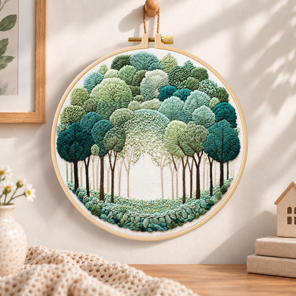 Green forest path embroidery hoop wall art displayed as warm and cozy handmade home decor