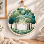 Green forest path embroidery hoop wall art displayed as warm and cozy handmade home decor