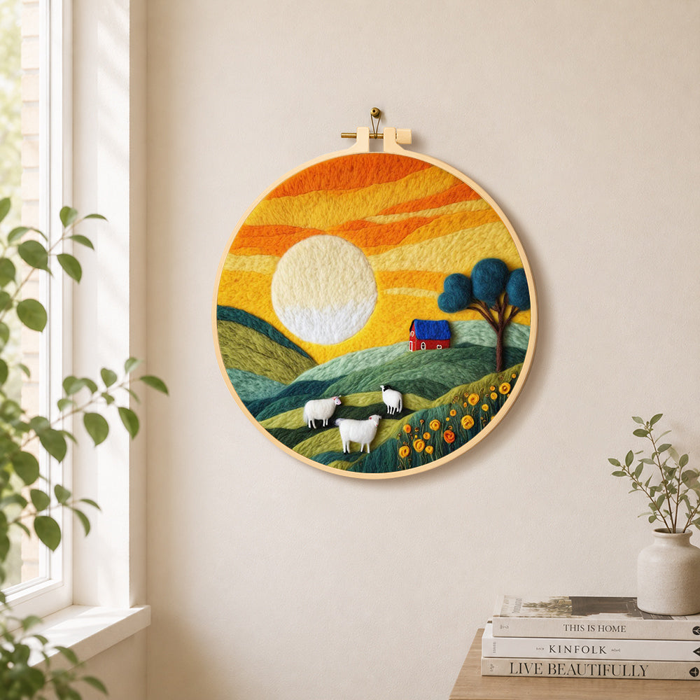 Green hills and fluffy sheep under golden sunset needle felt wall art displayed in a bright home interior