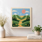 Finished green mountains and yellow wildflowers artwork displayed on a wall