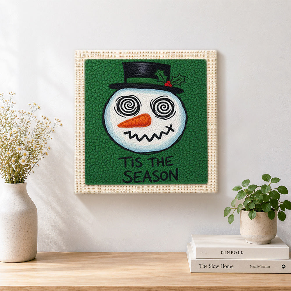Finished grinning spiral eye snowman artwork displayed on a wall