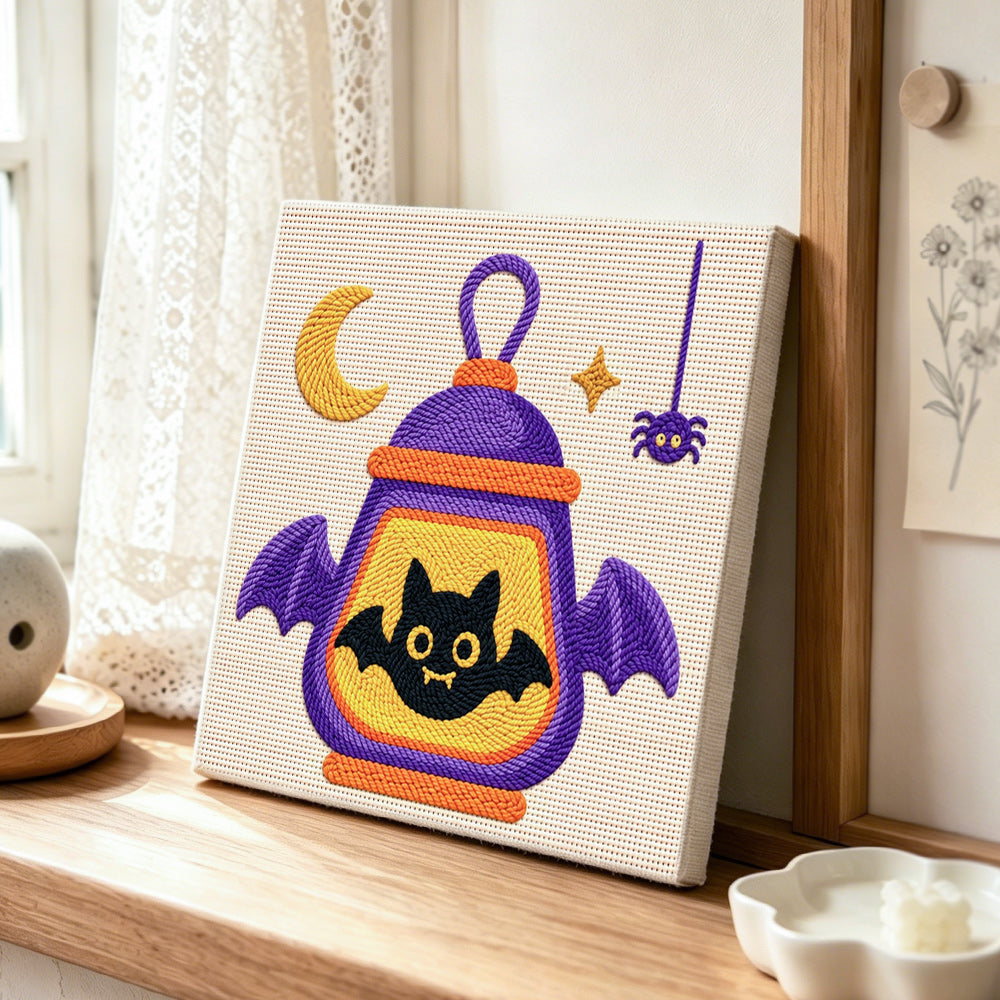 Halloween bat lantern punch needle artwork displayed on a table