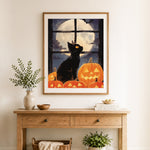 Finished halloween black cat and pumpkin cross stitch artwork displayed as home decor