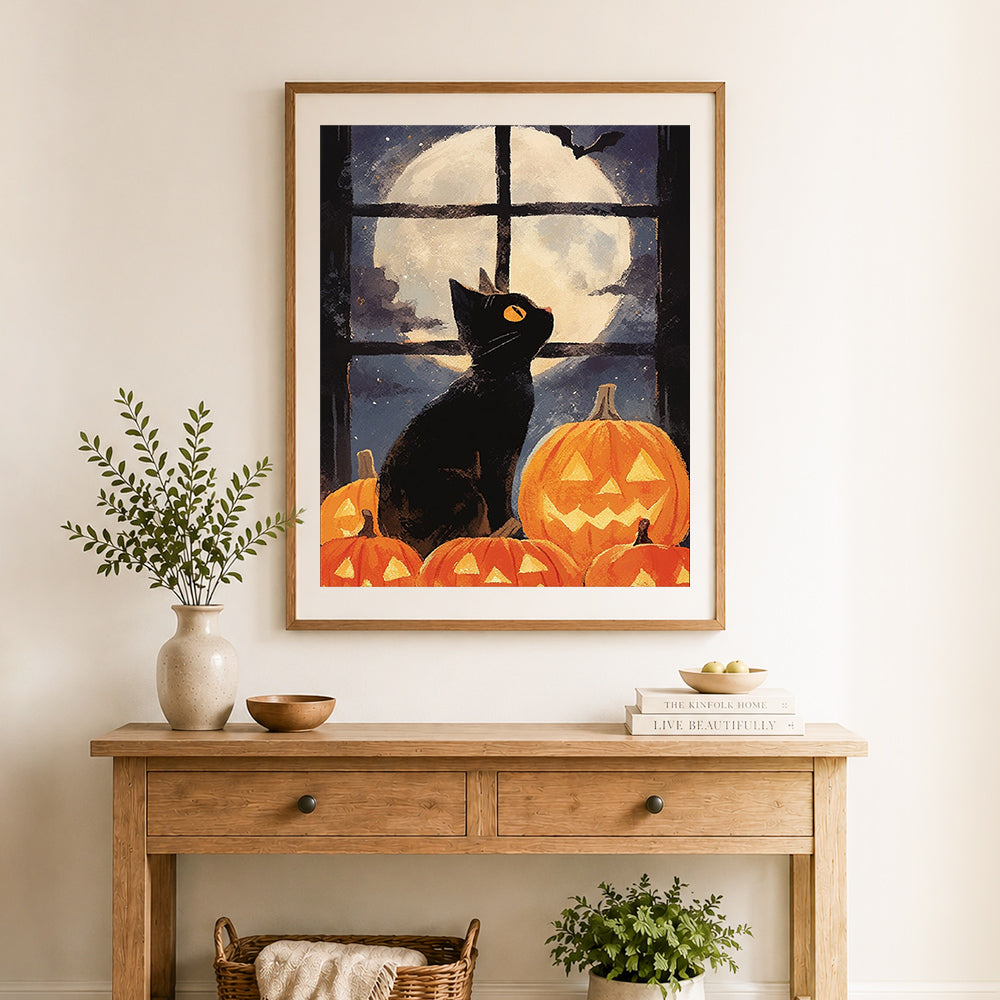 Finished halloween black cat and pumpkin cross stitch artwork displayed as home decor