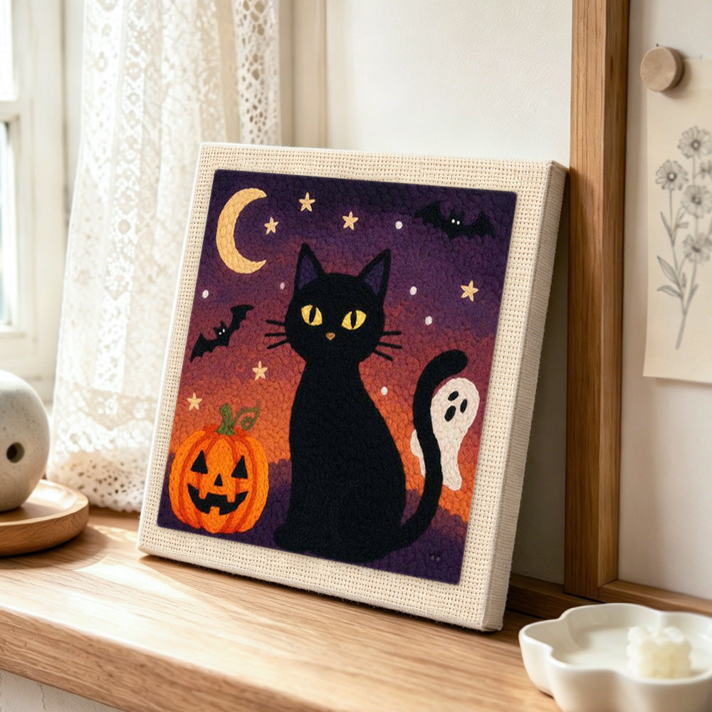 Halloween black cat night punch needle artwork displayed on a table