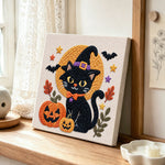 Halloween black cat punch needle artwork displayed on a table