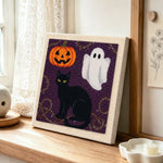 Halloween cat and ghost punch needle artwork displayed on a table