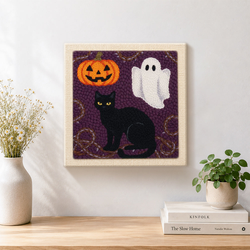 Finished halloween cat and ghost artwork displayed on a wall