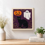 Finished halloween cat and ghost artwork displayed on a wall