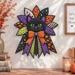 Halloween cat night quilted bow displayed as handmade wall decor in a cozy home