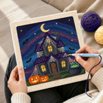 Creating handmade halloween haunted house punch needle artwork
