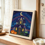 Halloween haunted house punch needle artwork displayed on a table