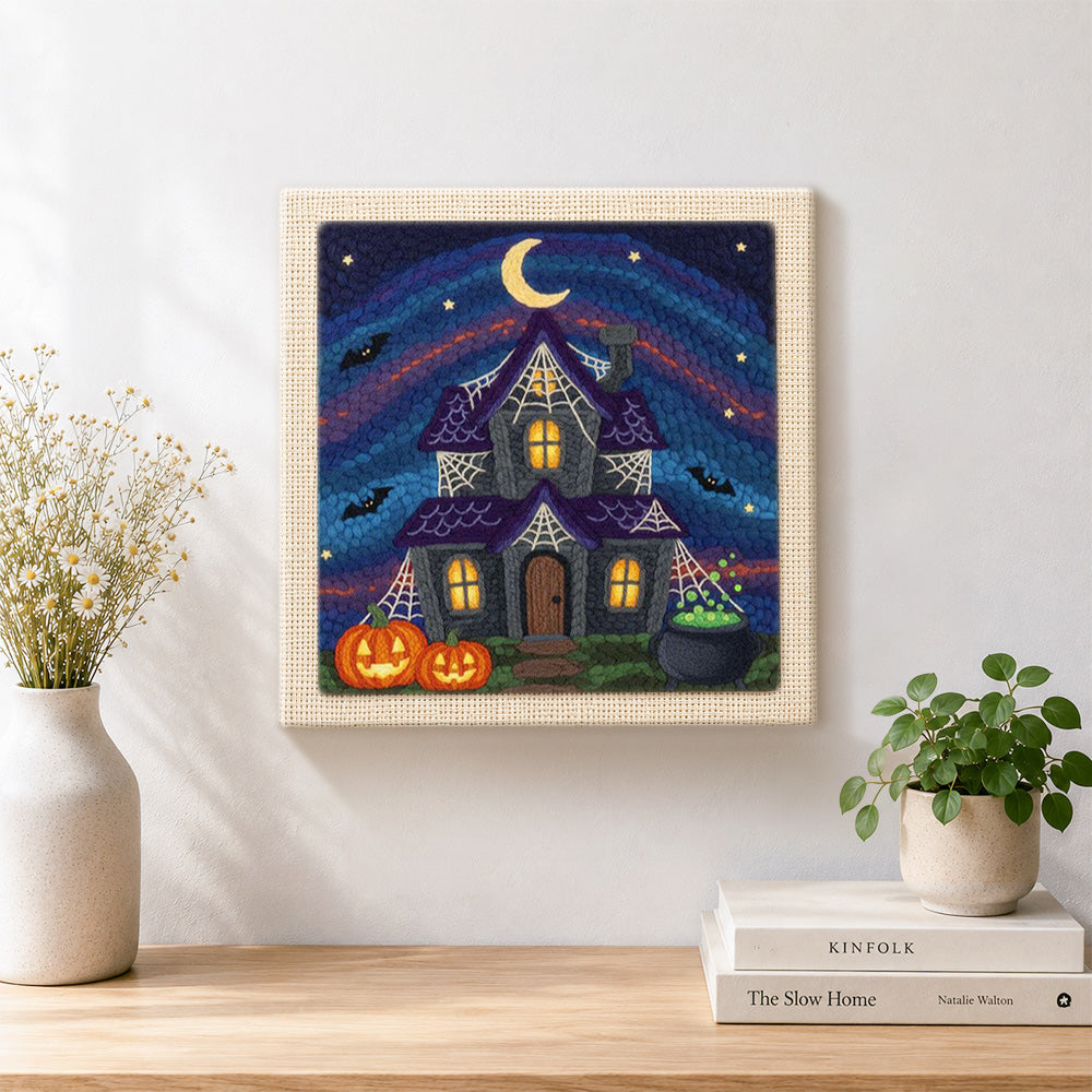 Finished halloween haunted house artwork displayed on a wall