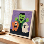Halloween monster trio punch needle artwork displayed on a table