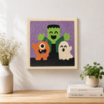 Finished halloween monster trio artwork displayed on a wall