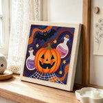 Halloween potion and bat punch needle artwork displayed on a table