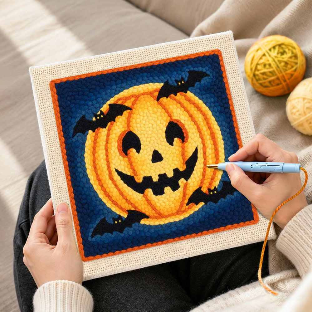 Creating handmade halloween pumpkin and bats punch needle artwork