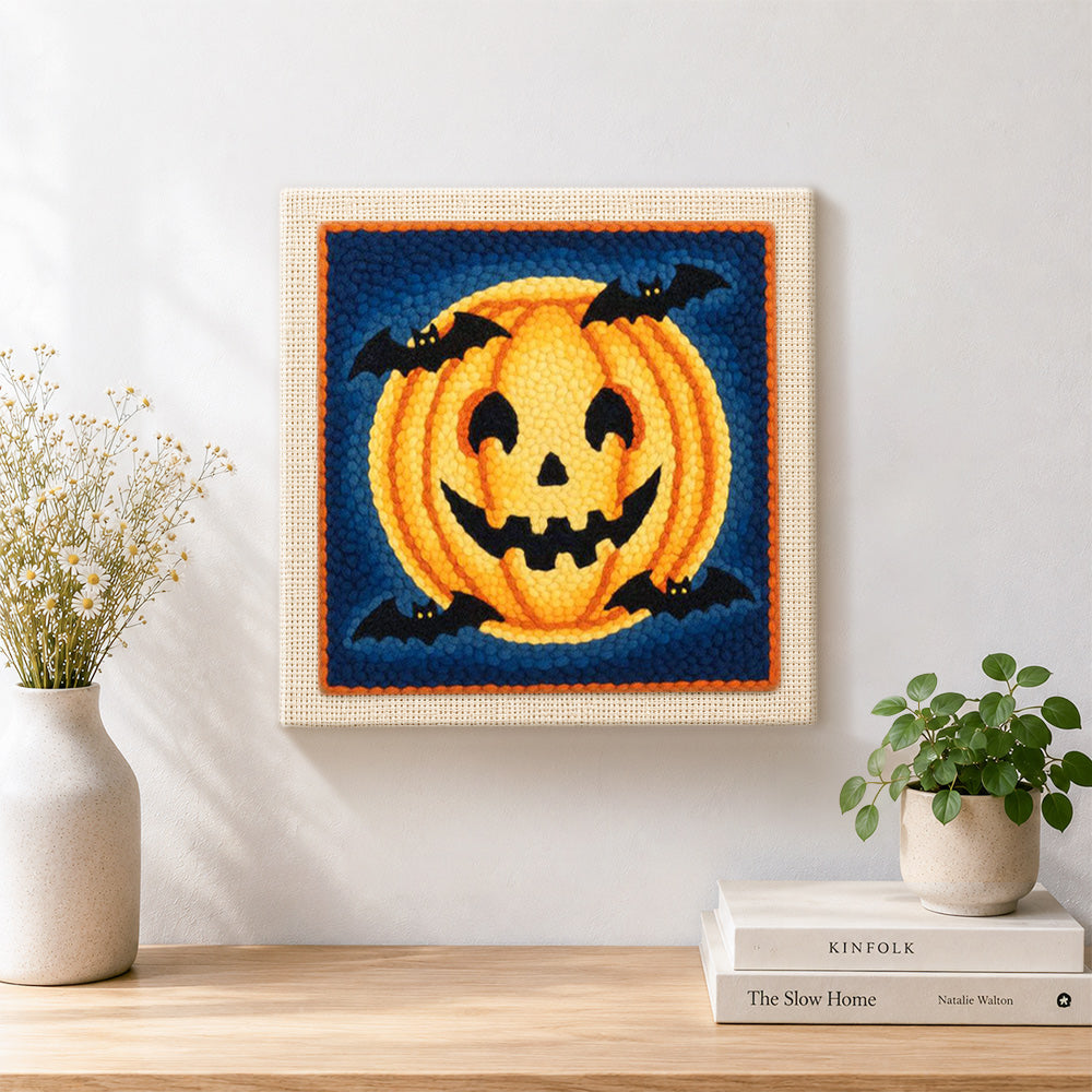 Finished halloween pumpkin and bats artwork displayed on a wall