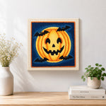 Finished halloween pumpkin and bats artwork displayed on a wall