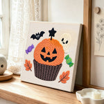 Halloween pumpkin cupcake punch needle artwork displayed on a table