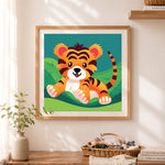 Finished happy baby tiger cross stitch artwork displayed as home decor