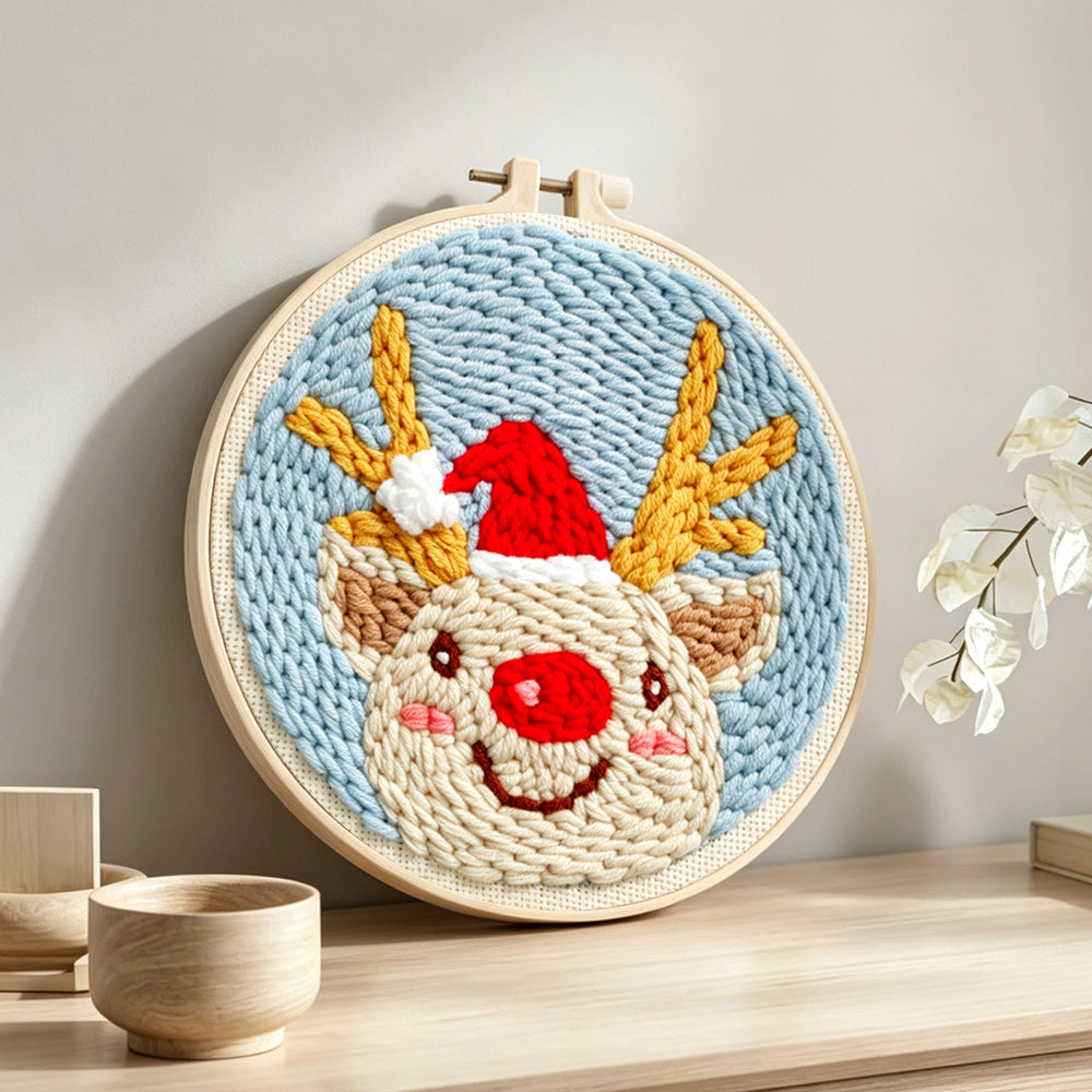Happy christmas reindeer punch needle artwork displayed on a table