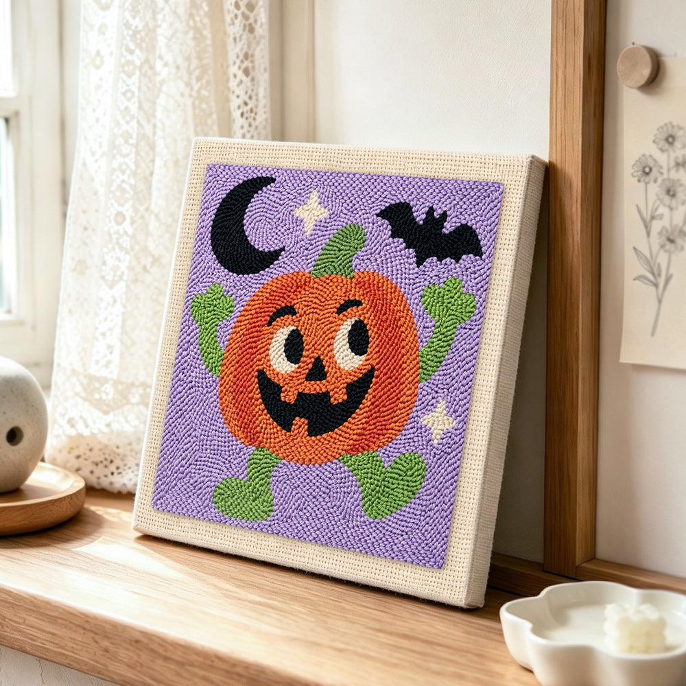 Happy dancing pumpkin character punch needle artwork displayed on a table
