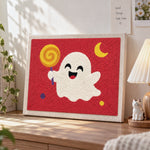 Happy ghost with lollipop punch needle artwork displayed on a table