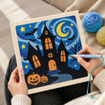 Creating handmade haunted house night scene punch needle artwork