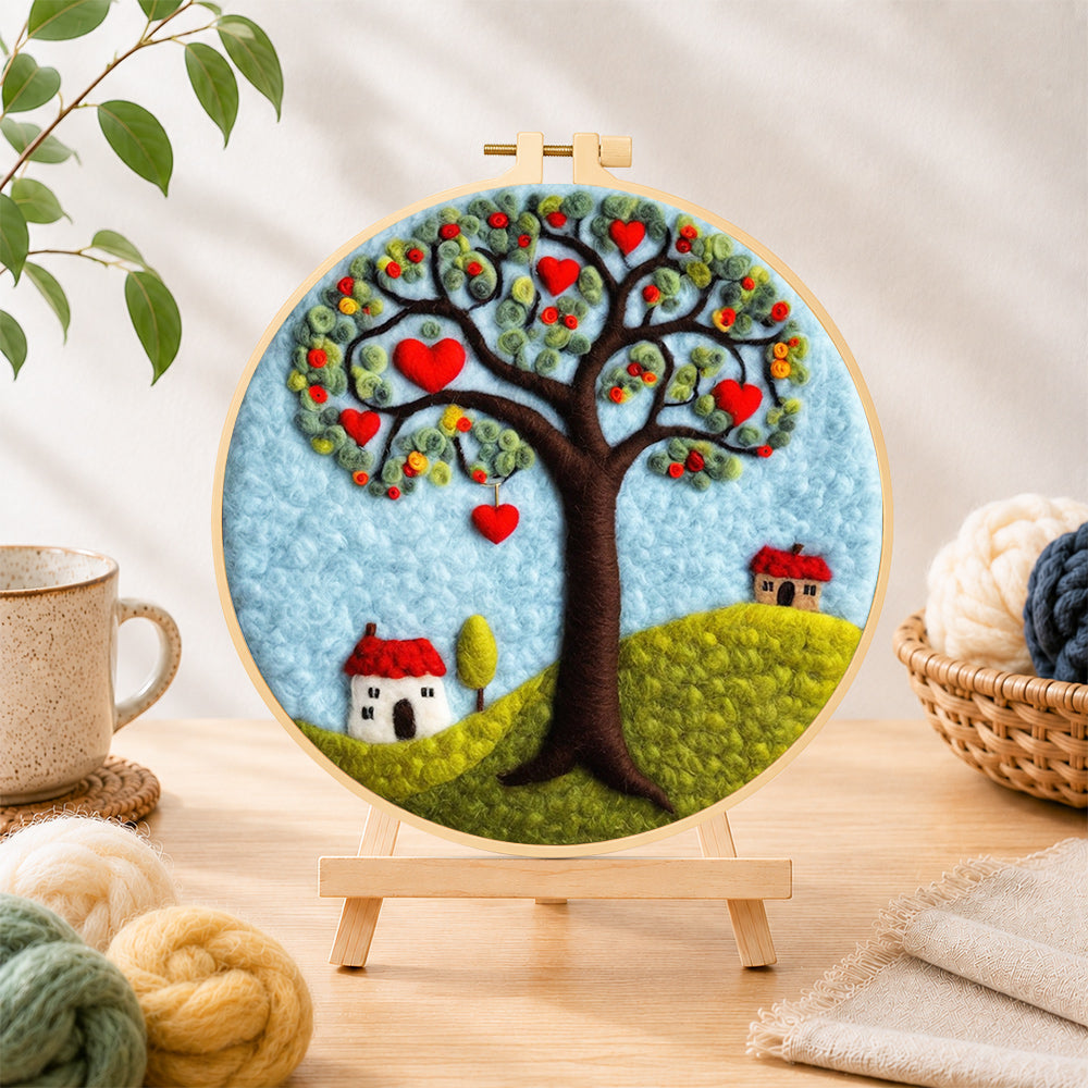 Finished heart tree and little houses needle felting displayed on a wooden easel