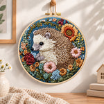 Hedgehog with sunflower blooms embroidery hoop wall art displayed as warm and cozy handmade home decor