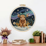 Finished highland cow, mountains and sunflowers artwork displayed on a wall