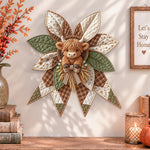 Highland cow quilted bow displayed as handmade wall decor in a cozy home