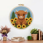 Finished highland cow surrounded by sunflowers artwork displayed on a wall