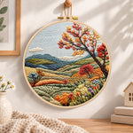Hillside fall tree view embroidery hoop wall art displayed as warm and cozy handmade home decor