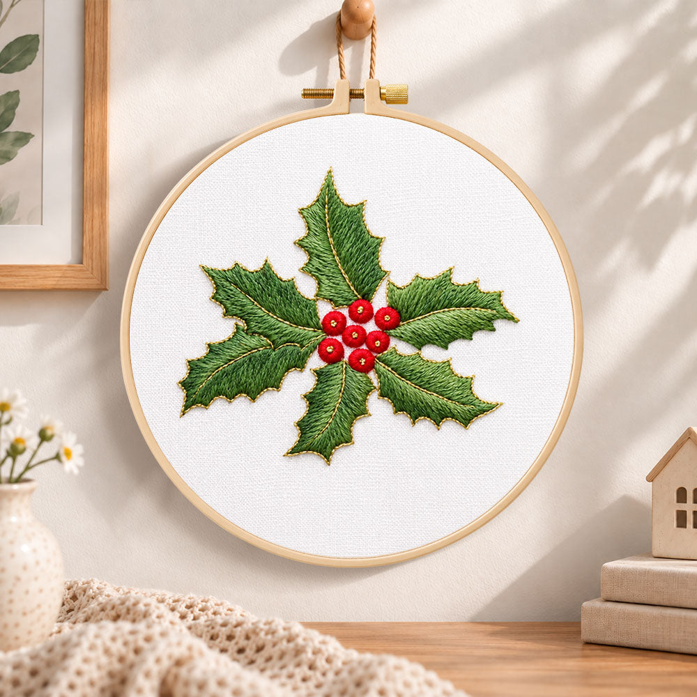 Holly leaves and berries embroidery hoop wall art displayed as warm and cozy handmade home decor