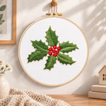 Holly leaves and berries embroidery hoop wall art displayed as warm and cozy handmade home decor