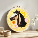 Horse and colorful flowers punch needle artwork displayed on a table