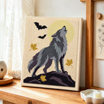 Howling wolf under full moon punch needle artwork displayed on a table