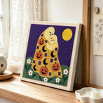 Hugging ghosts with pumpkins punch needle artwork displayed on a table
