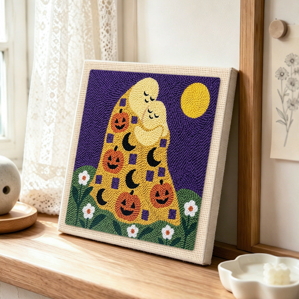 Hugging ghosts with pumpkins punch needle artwork displayed on a table