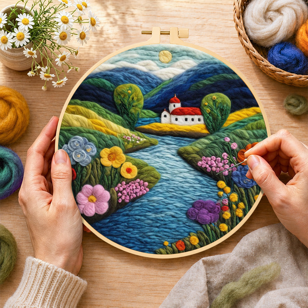 Creating the idyllic mountain village and river wool painting by hand with a felting needle